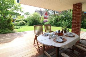 a table and chairs on a patio with a table and chairs at Ferienhaus Uli in Wustrow +19 photos