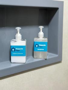 two bottles of hand sanitizers sitting on a shelf at Studio Atalaia - C -308 - By Hospede Fácil in Brasília +13 photos