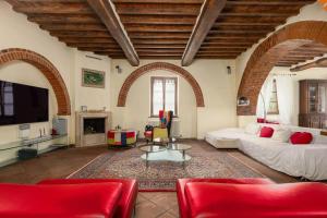 a large living room with a couch and a tv at Podere Il Pozzangone by Geco Vacation Rentals in Lucignano