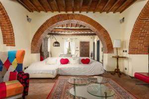 a bedroom with a bed with two red heart pillows at Podere Il Pozzangone by Geco Vacation Rentals in Lucignano +48 photos