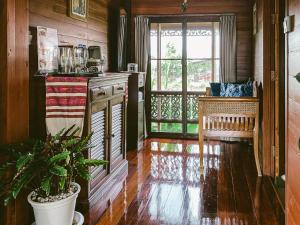 a kitchen with a counter and a window with a plant at Rommai Villa Chiang Rai in Ban Pa Sang (1)