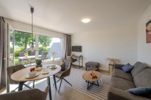 a living room with a couch and a table at Boddenweite 3 in Born