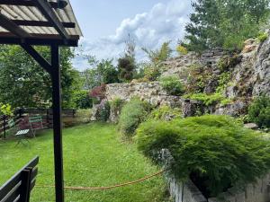 a view of a garden from the porch of a house at Ferienwohnung im Grünen in Gößweinstein