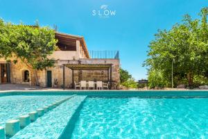 a swimming pool in front of a house at Villa Bandris by Slow Villas in Manacor