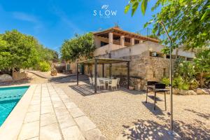 a villa with a swimming pool and a house at Villa Bandris by Slow Villas in Manacor