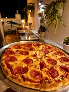 a pepperoni pizza sitting on top of a table at Knossos Breeze in Sitia +7 photos