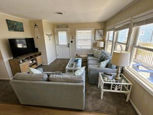 a living room with two couches and a tv at N6913- Heidaway (Formerly Devlin's Roost) in Nags Head
