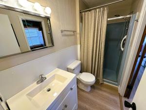 a bathroom with a sink and a toilet and a shower at N6913- Heidaway (Formerly Devlin's Roost) in Nags Head +18 photos