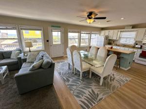 a kitchen and living room with a table and chairs at N6913- Heidaway (Formerly Devlin's Roost) in Nags Head