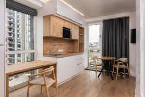 a kitchen with a table and chairs and a dining room at Lumen Living in Kyiv