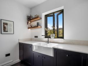 a kitchen with a sink and a window at Sweet Garden in Ballyconneely +29 photos