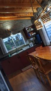 a dining room with a table and some windows at Propost place in Kijabe