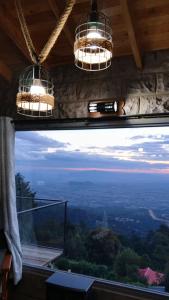 a window in a room with two chandeliers at Propost place in Kijabe +14 photos