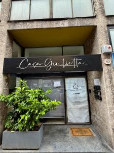 a store with a sign on the front of a building at Boutique Casa Giulietta in Como