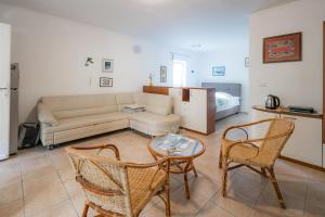 a living room with a couch and a table and chairs at Green Oasis by the Sea in Koper