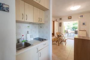 a kitchen and living room with a sink and a table at Green Oasis by the Sea in Koper