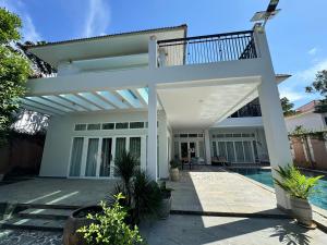 a house with a patio and a swimming pool at An Nhien Mercury Villa & Resort in Phú Quốc