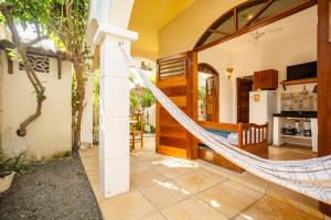 a hammock in the living room of a house at Villa Medina Oasis in Jericoacoara