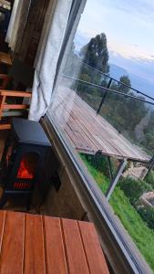 a view of a window with a picnic table and a fireplace at Propost place in Kijabe