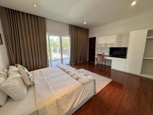 a large bedroom with a large bed and a desk at An Nhien Mercury Villa & Resort in Phú Quốc