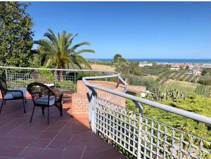 a balcony with chairs and a view of the ocean at Villa Maria Giuseppina a San Benedetto del Tronto in Monteprandone