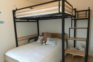 a bedroom with two bunk beds with a teddy bear on the bed at Spacious and bright 125m2 apartment in Berck in Berck-sur-Mer