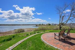 a bench sitting on a brick path next to a lake at Kelley Lane - CHT- KL161 in Chatham