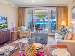a living room with a table with a pineapple on it at Villa 317 at Turtle Bay in Kahuku