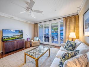 a living room with a couch and a tv at Villa 317 at Turtle Bay in Kahuku