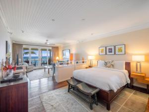 a bedroom with a bed and a living room at Villa 317 at Turtle Bay in Kahuku +39 photos