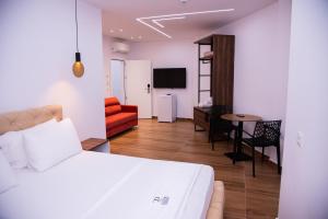 a bedroom with a bed and a living room at Dine Residence in Himare
