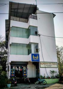 a white building with motorcycles parked in front of it at Kutumba Home in Bhairāhawā