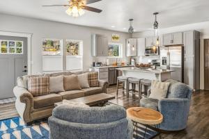 a living room with a couch and chairs and a kitchen at Big Blue Basecamp in Ouray CO in Ouray