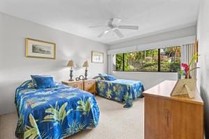 a bedroom with two beds and a window at Keauhou Punahele#D-206 in Kailua-Kona +20 photos