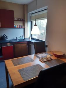 a kitchen with a wooden table and a dining room at Ferienwohnung Oelstorf in Eckernförde