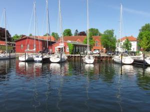 a group of boats docked at a marina with houses at Ferienwohnung Oelstorf in Eckernförde