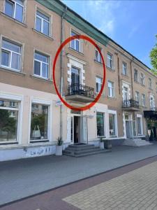 a red circle is on the side of a building at Мazvydo Avenue Studio Кlaipeda City Centre in Klaipėda