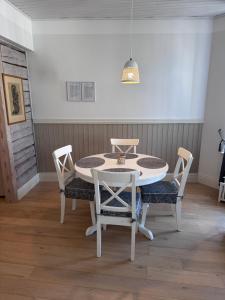 a dining room with a table and four chairs at Karja Apartment with sauna in Haapsalu +10 photos