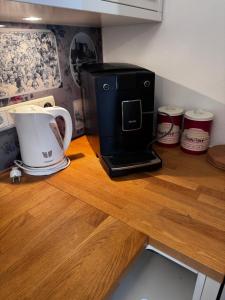 a counter with a coffee maker and a toaster on it at Karja Apartment with sauna in Haapsalu
