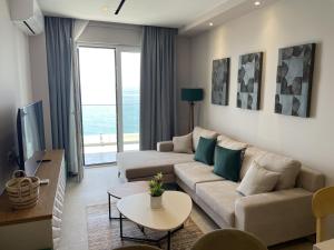 a living room with a couch and a table at DreamStay Lezha Apartments - Ilyonis Residence in Lezhë