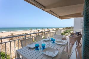 a table on the balcony with a view of the beach at AG LAS SIRENAS in Playa de Gandia
