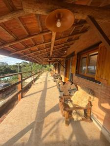 a row of benches sitting on the side of a building at Rancho do Ipês in Campos do Jordão