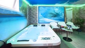 a bath tub in a room with a painting at Exclusiv Ferienwohnung Maarpanorama in Schalkenmehren