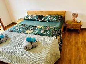 a bedroom with two beds with towels on the bed at Casa Marysol in Ventimiglia