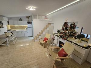 a living room with a christmas tree and a fireplace at Duplex Marquis in Braşov