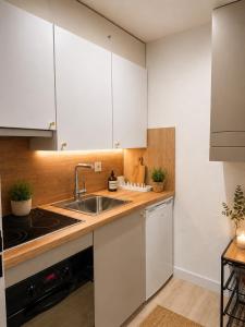 a kitchen with white cabinets and a sink at Holiday Leukerbad Ruhe Natur Berge Free Parking 80 in Leukerbad