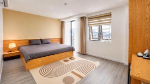 a bedroom with a bed and a window at Gabi Boutique Hotel in Mộc Châu +43 photos