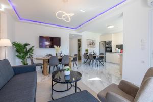a living room with a couch and a table at Casa Eda in Agia Marina Nea Kydonias