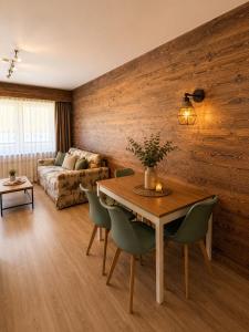 a living room with a table and a couch at Holiday Leukerbad Ruhe Natur Berge Free Parking 80 in Leukerbad