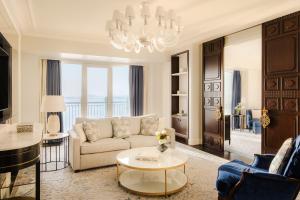 a living room with a couch and a table at Four Seasons Hotel Doha in Doha